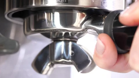 Grinding fresh coffee beans with a grinder or portafilter to make hot Arabica Stock Footage 256498492