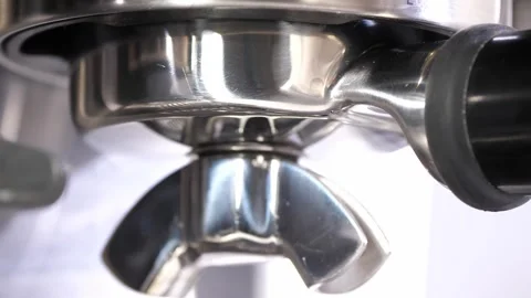 Grinding fresh coffee beans with a grinder or portafilter to make hot Arabica Stock Footage 258622224