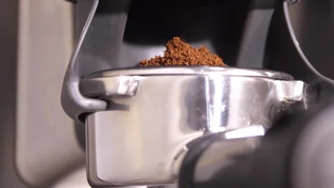 Grinding fresh coffee beans with a grinder or portafilter to make hot Arabica Stock Footage 258622246