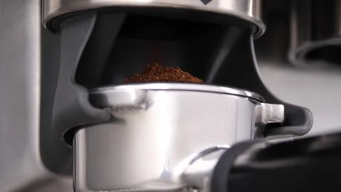 Grinding fresh coffee beans with a grinder or portafilter to make hot Arabica Stock Footage 259753941