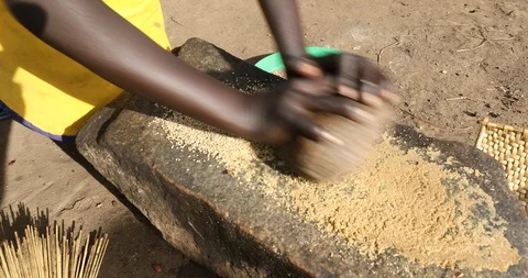 Grinding the Grain in a Refugee Settlement Stock Footage 93914320