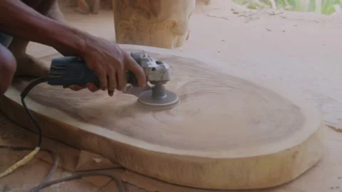 A grinding machine works in a carpentry workshop, a carpenter sands wood, as Vidéo 256548010