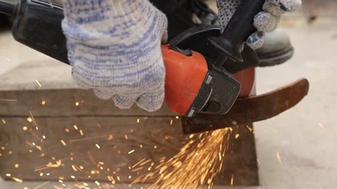 Grinding metal causes sparks in workshop setting Stock Footage 344181223