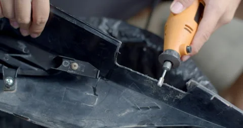 Grinding a metal workpiece with a handheld tool, creating sparks and shaping. Stock Footage 321798868