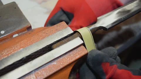 Grinding an old chisel on disks in the workshop. Stock Footage 155885085