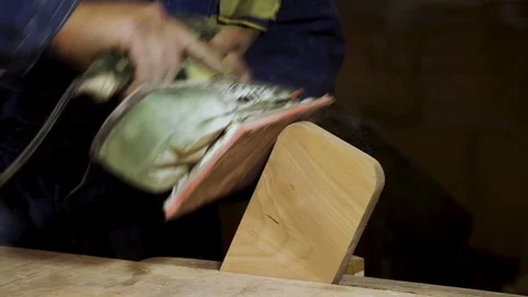 Grinding a piece of wood in the carpentry workshop close-up.  Stock Footage 100805357