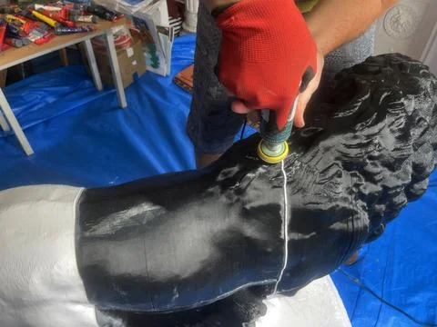 Grinding plastic with a drill. handmade work statue Lion Medici Stock Photos