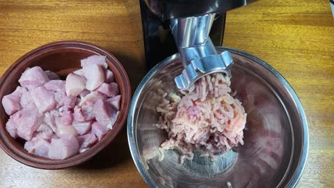 Grinding poultry meat into ground meat with electric meat grinder Stock Footage 330951589