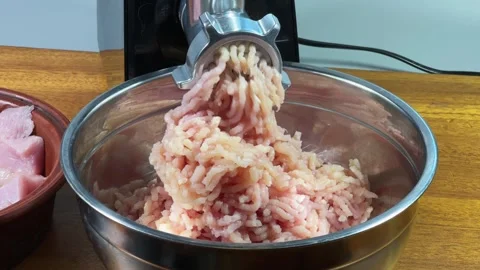 Grinding poultry meat into ground meat with electric meat grinder Stock Footage 330951625