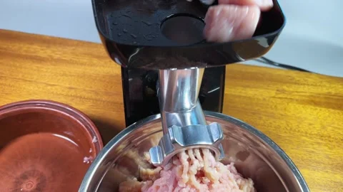 Grinding poultry meat into ground meat with electric meat grinder Stock Footage 330951693