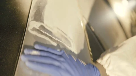 The grinding primered car surface with grind machine. 4K Stock Footage 86828963