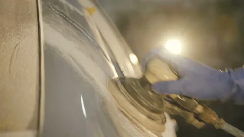 The grinding primered car surface with grind machine. 4K Stock Footage 86829328