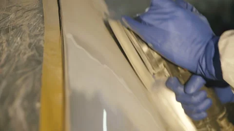 The grinding primered car surface with grind machine. 4K Stock Footage 86829804