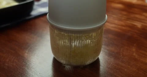 Grinding process in an electric Garlic grinder. Electro Meat grinder makes Stock Footage 328740995