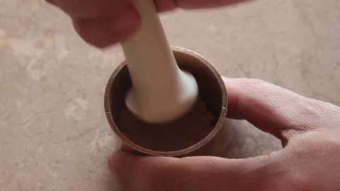 Grinding in a small brass mortar Stock Footage 88702049