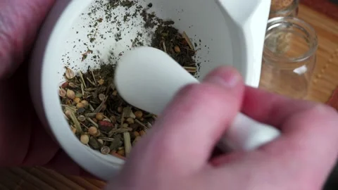 Grinding spices herbs in a mortar with pestle Stock Footage 149145341