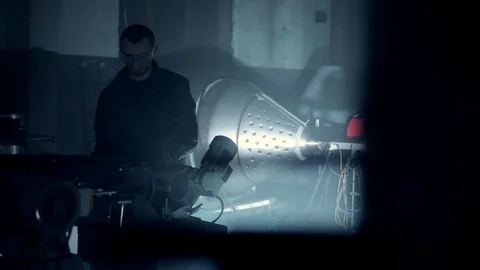 Grinding stainless steel pipe. the man behind the machine. Stock Footage 124635322