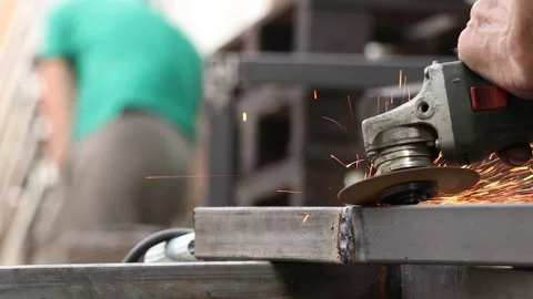 Grinding a weld on metal structures with a grinder, a master working Stock Footage 311301673