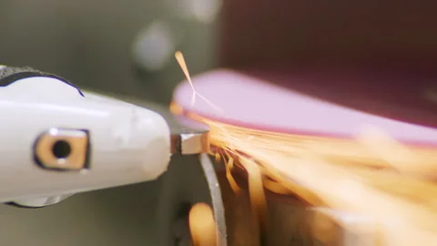 Grinding wheel spins fast throwing bright sparks in workshop Vídeo Stock 326001779