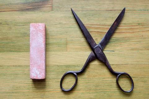 Grindstone with scissors Stock Photos
