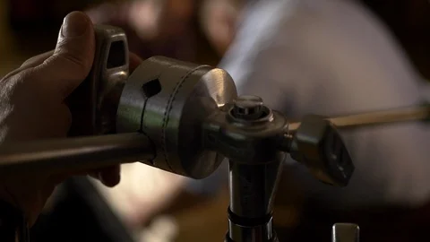 A grip adjusts a C-stand and flag on a video production set. Stock Footage 99426200