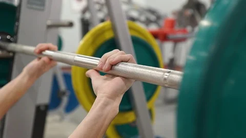 Grip - barbell bench press. Man grips bar for barbell bench press. Macro. Focus Stock Footage 103040875