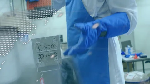 Gripping cryogenic dewar gloved technician retrieving vials via code overlay for Stock-Footage 310325469