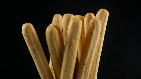 Grissini close up on black background Stock Footage 103424492