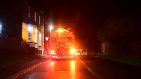 Gritter spreading rock salt in wintertime at night uk Stock Footage 123777970