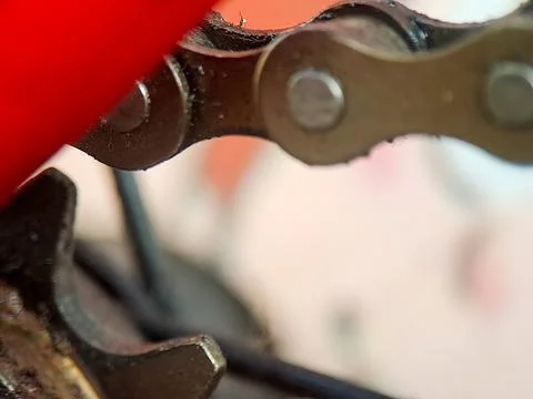 A gritty bicycle chain segment connected by pins and worn by friction again.. Stock Photos