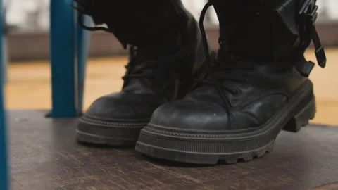 Gritty city scene featuring rugged platform footwear with lamplight. Detailed Stock Footage 345529116