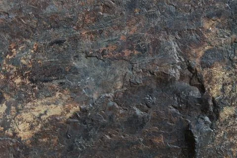 Gritty dark grey rock surface heavily textured with bright brown rust miner.. Stock Photos