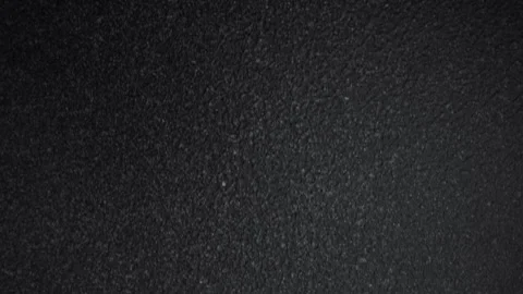 Gritty graphite texture surface. Abstract black real background. Dolly top view. Stock Footage 245717812