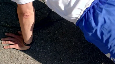 Gritty urban setting with man doing fitness exercises outdoors Stock Footage 320956408