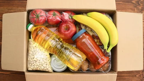 Groceries being packed in a box to be delivered, top view, time lapse Stock Footage 135831871