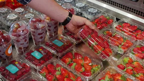 Grocery buyer putting strawberry box into the shopping cart 스톡 동영상 200838053