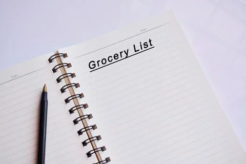 Grocery list text on a notepad with reflection of window glass Stock Photos