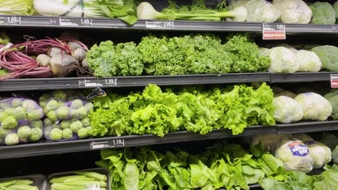 Grocery store fresh greens and misting system spraying water over fresh veg.. Stock Footage 235393520