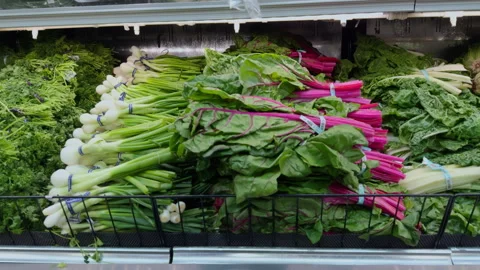 Grocery store with fresh packed leafy greens neatly displayed on shelves. Close Stock Footage 317208566