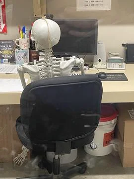 Grocery store A skeleton sitting in a managers office Stockfoto's