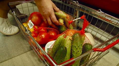 Grocery Store. Vegetable Section. Female Assistant Taking Cucumbers From the Stock Footage 68031451
