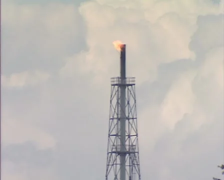 GRONINGEN, THE NETHERLANDS - Flare stack + zoom out shed in rural landscape Stock Footage 46708867