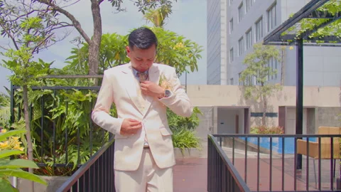 Groom Adjusting Suit Jacket While Looking Around On Wedding Preparation Moment Video stock 333375658
