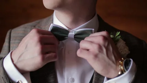 The groom adjusts the bow tie. Close-up. Preparation for the wedding celebration Stock Footage 201523414