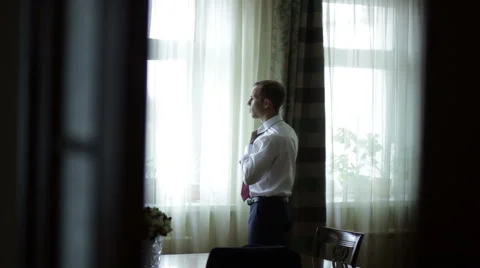 The groom adjusts his collar. Stock Footage 56770892