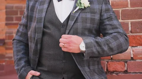 The groom adjusts his jacket before the wedding ceremony Stock Footage 327983088