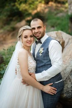The groom and the bride are walking in the forest Stock Photos