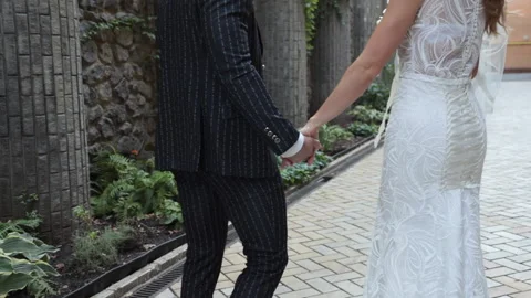 The groom and the bride join hands and leave Stock Footage 143773153
