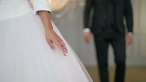 Groom is approaching to bride and taking her hand, love and tenderness in Stock Footage 166099758