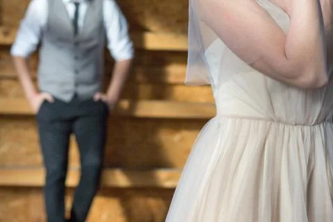 The groom in the background, the bride in the foreground. Stock Photos